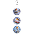 Hanging suncatcher of three round glass discs with winter robin scenes, linked by chain below a hook, on white
