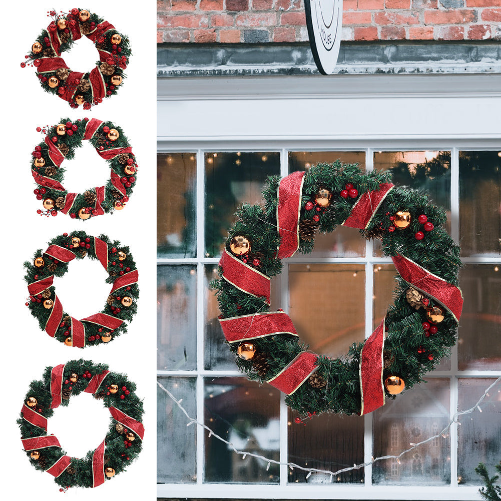Four red ribbon Christmas wreaths on white beside a larger ribbon wreath hung on a shop window