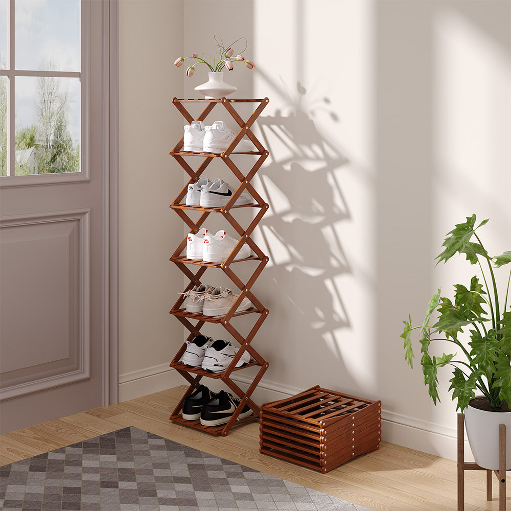 Dark brown folding shoe rack with shoes by a front door