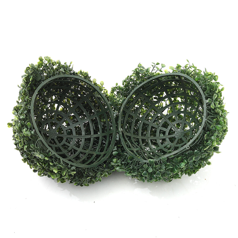 The two halves of the artificial boxwood ball opened to show the green plastic frames inside