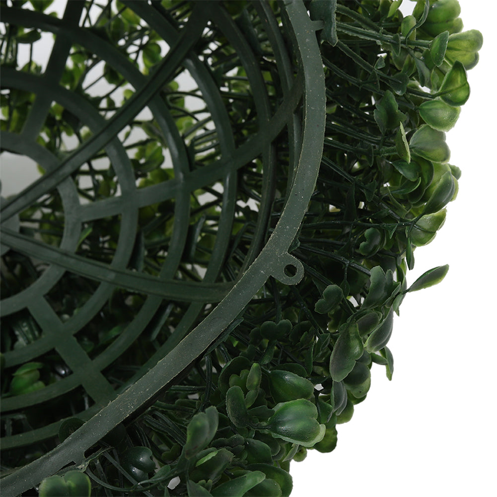 Close-up of the plastic frame inside one half of the boxwood ball, with small clips on the rim