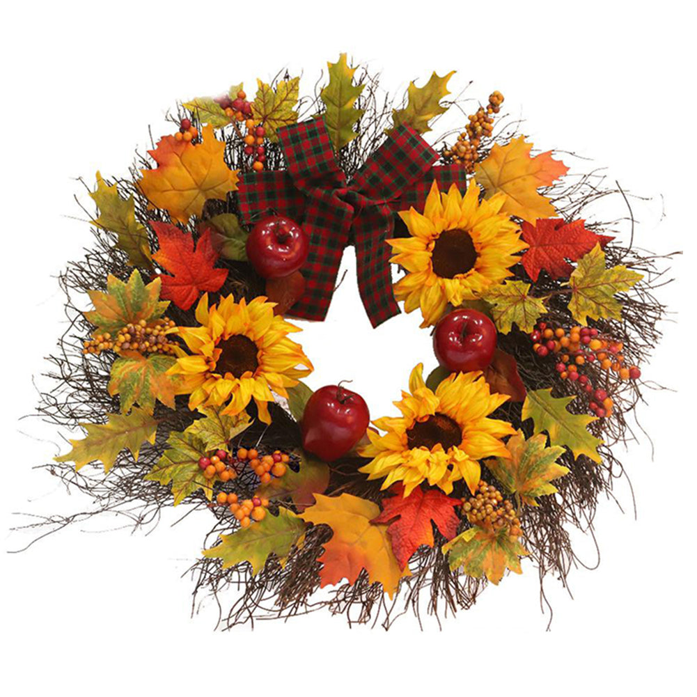 Artificial wreath of sunflowers, maple leaves, berries and red fruits with a red and black plaid bow, on white