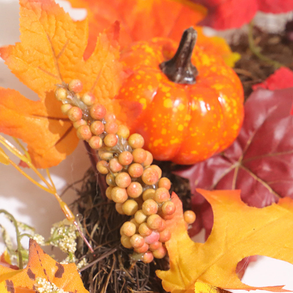 Close-up of a small orange pumpkin and orange berries among the maple leaves