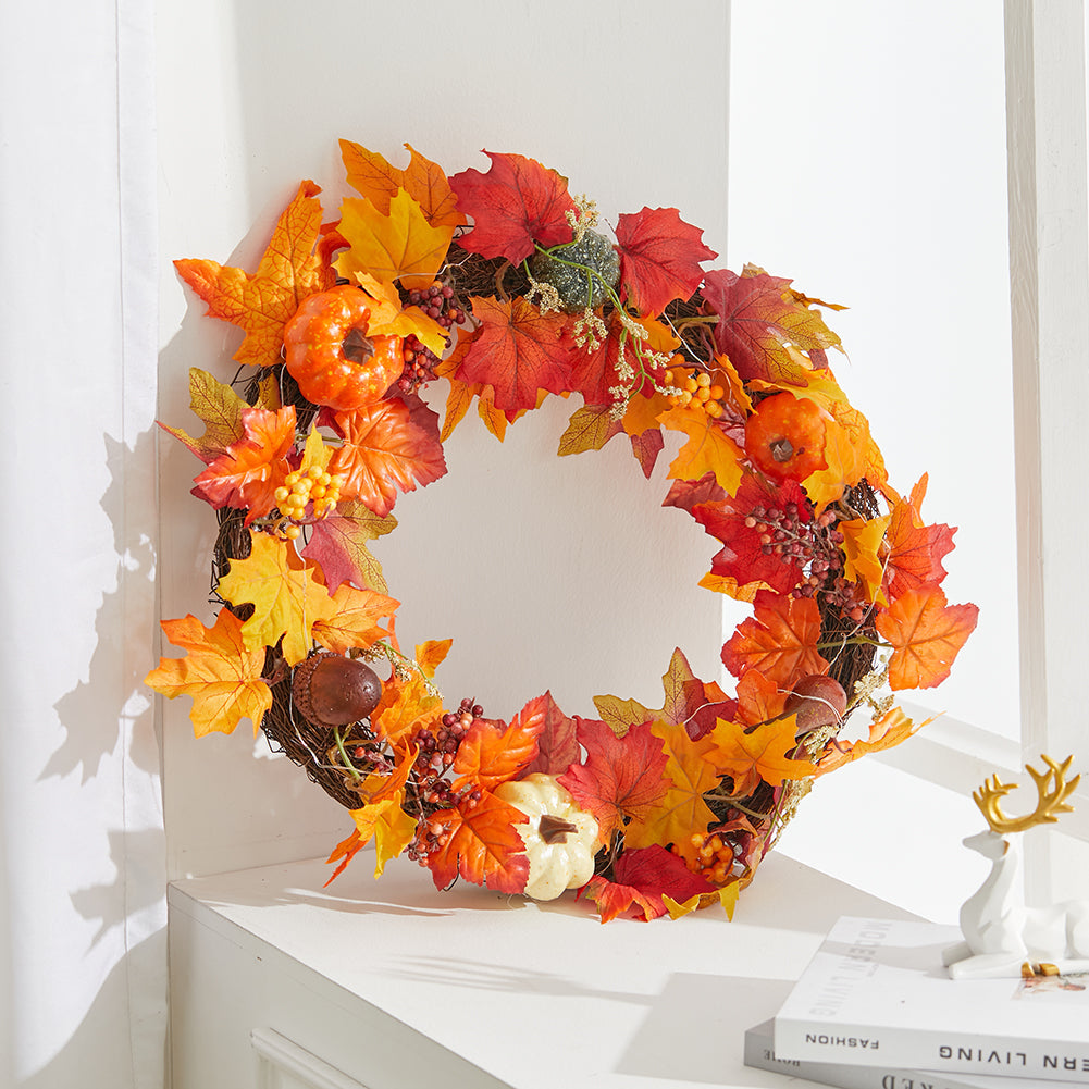The autumn wreath hanging above a white shelf