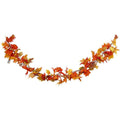 Maple leaf and pumpkin garland hanging in a curve on a white background, battery box at the left end