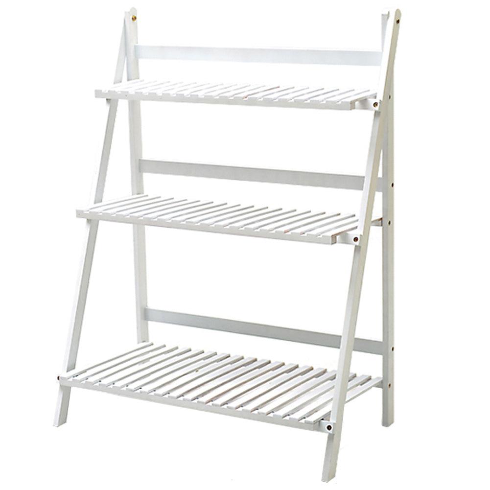 Empty white ladder plant stand with three slatted shelves on white