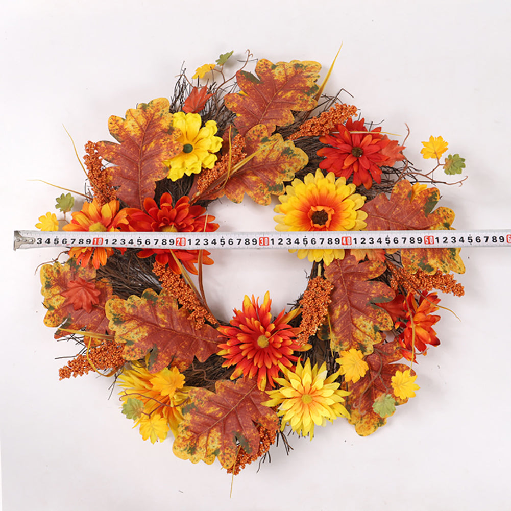 The daisy wreath laid on white with a measuring tape across it