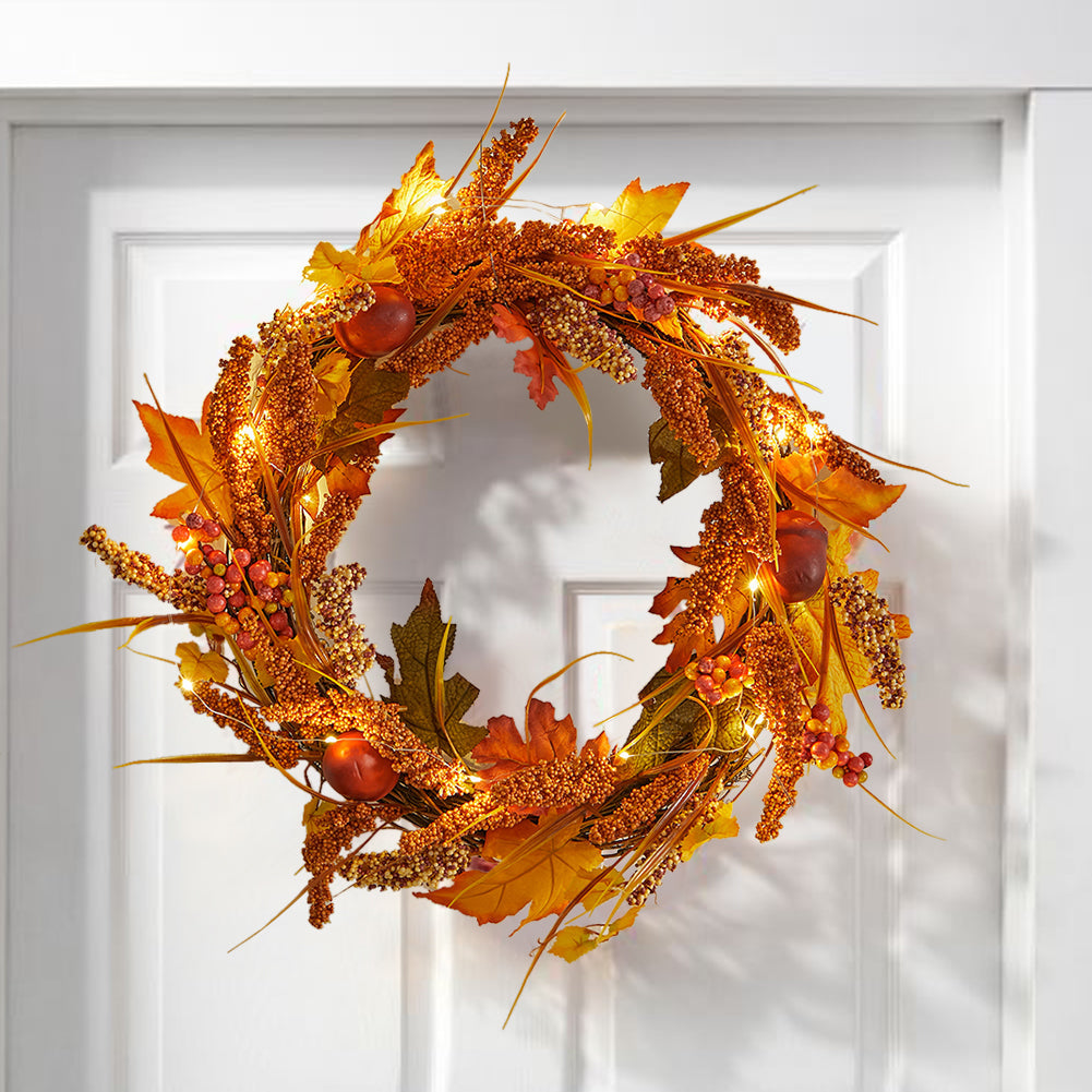 Sorghum and maple leaf wreath hanging on a white panelled front door