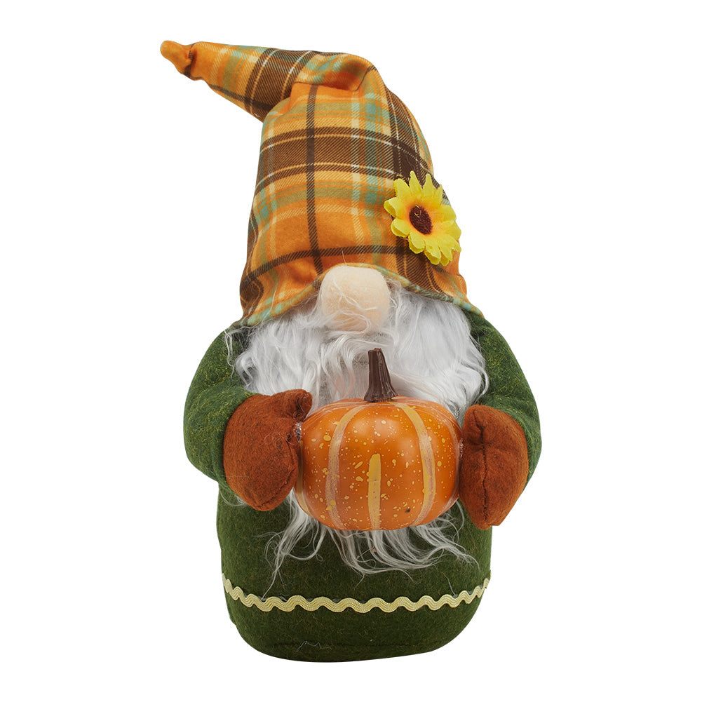 Fabric gnome with an orange plaid hat and sunflower, long white beard and green body holding an orange pumpkin, on white