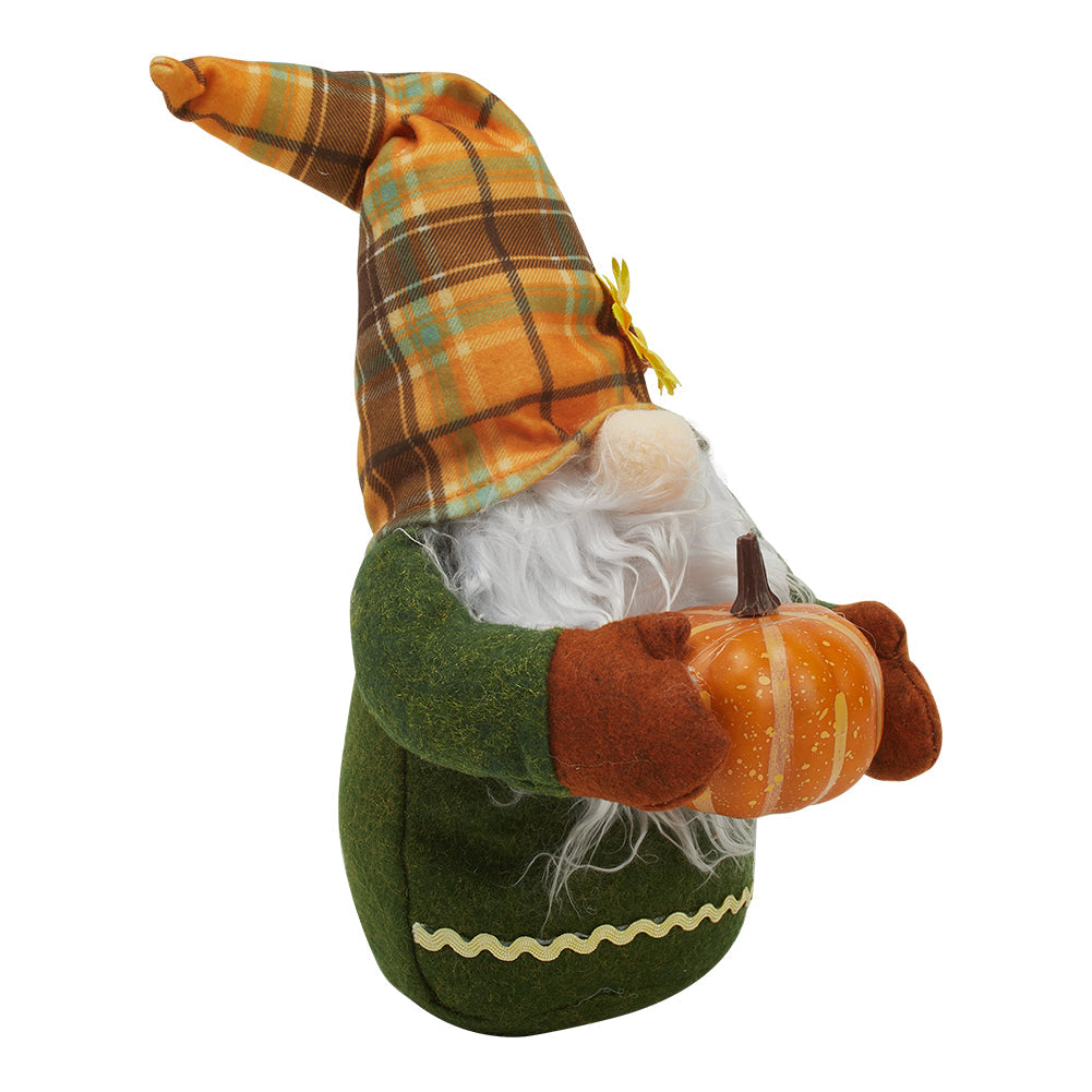 Side view of the autumn gnome on white showing its pointed plaid hat and the pumpkin in its mittens