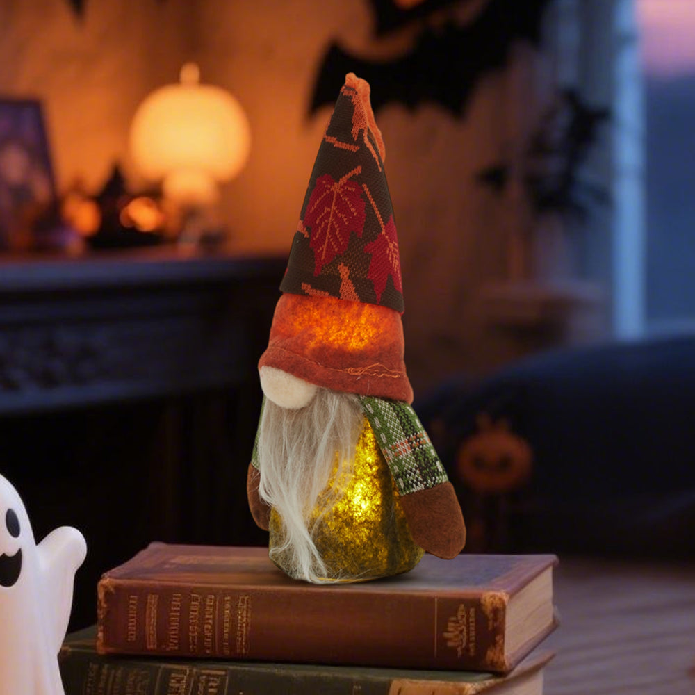 Autumn gnome glowing warmly on a stack of old books in a dim room