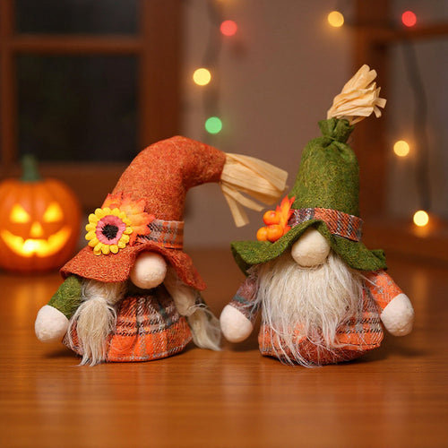 Orange-hatted and green-hatted plaid gnomes side by side on a wooden table with fairy lights behind