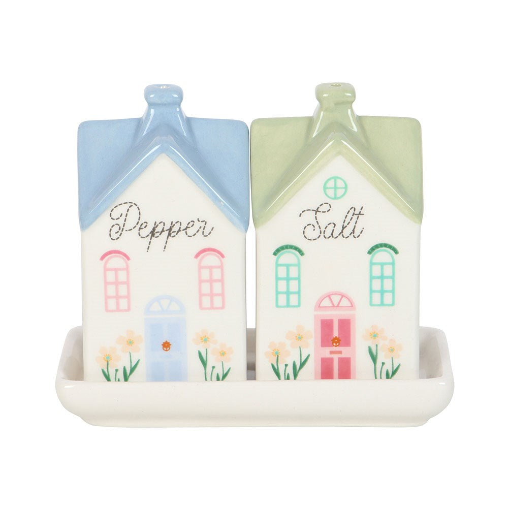 Pepper and Salt house shakers with pale blue and sage green roofs on a white ceramic tray