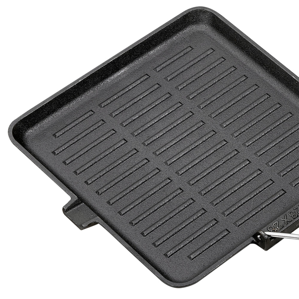 Angled view of the ribbed grill pan surface