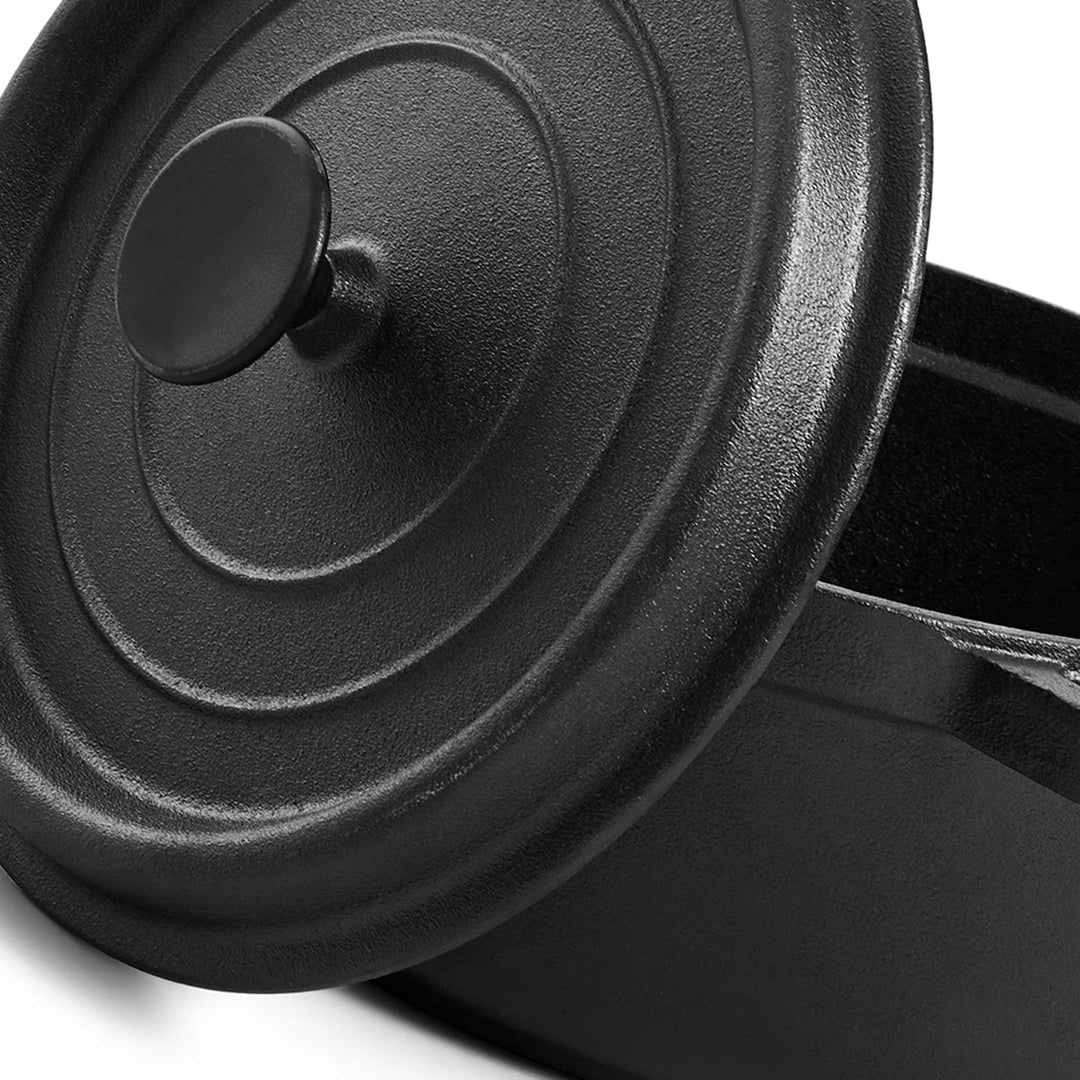 Close-up of the cast iron lid with raised concentric rings and a round black knob