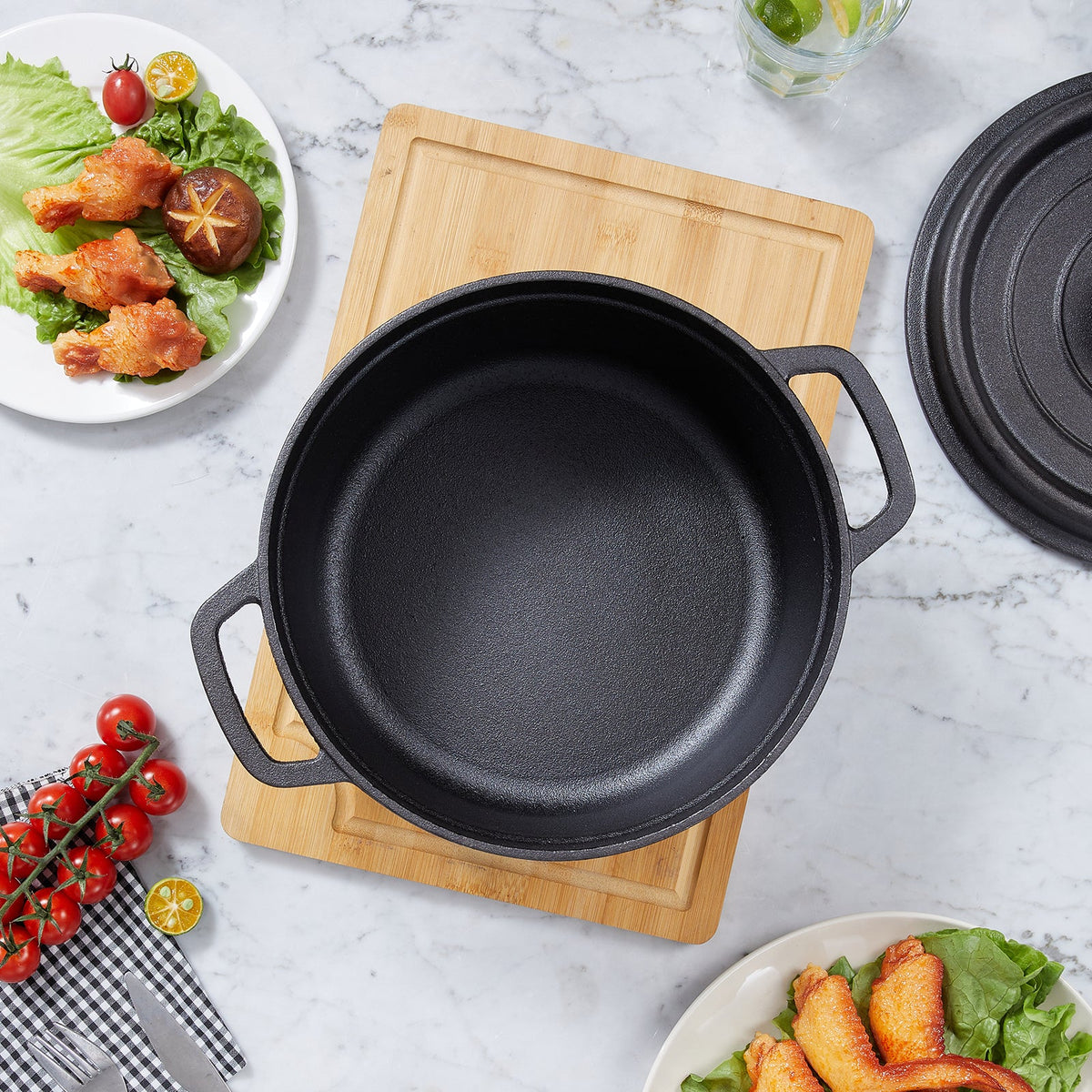 Top view of the empty cast iron pot on a bamboo board, showing the textured interior and loop handles