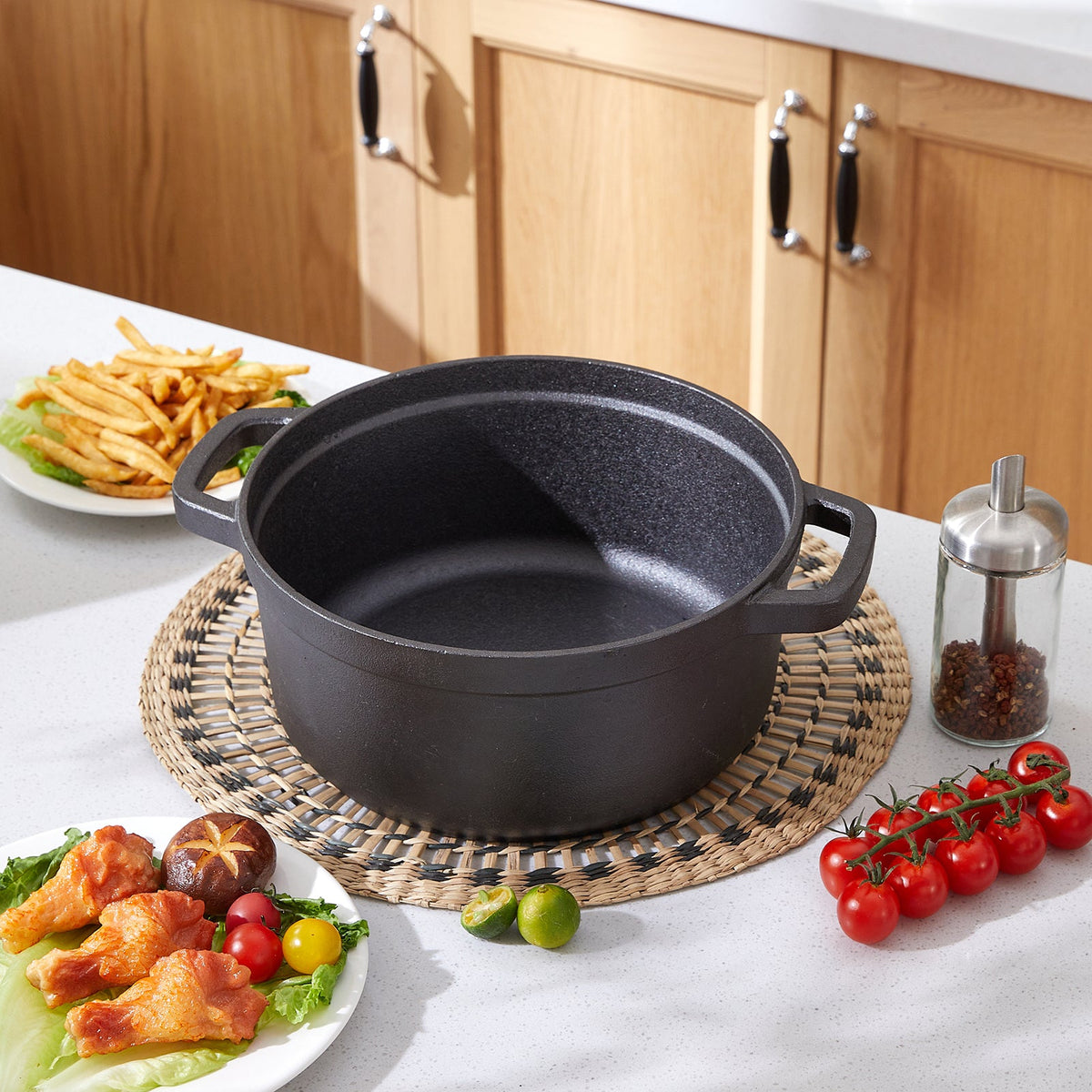 Empty black cast iron Dutch oven on a woven placemat on a kitchen worktop