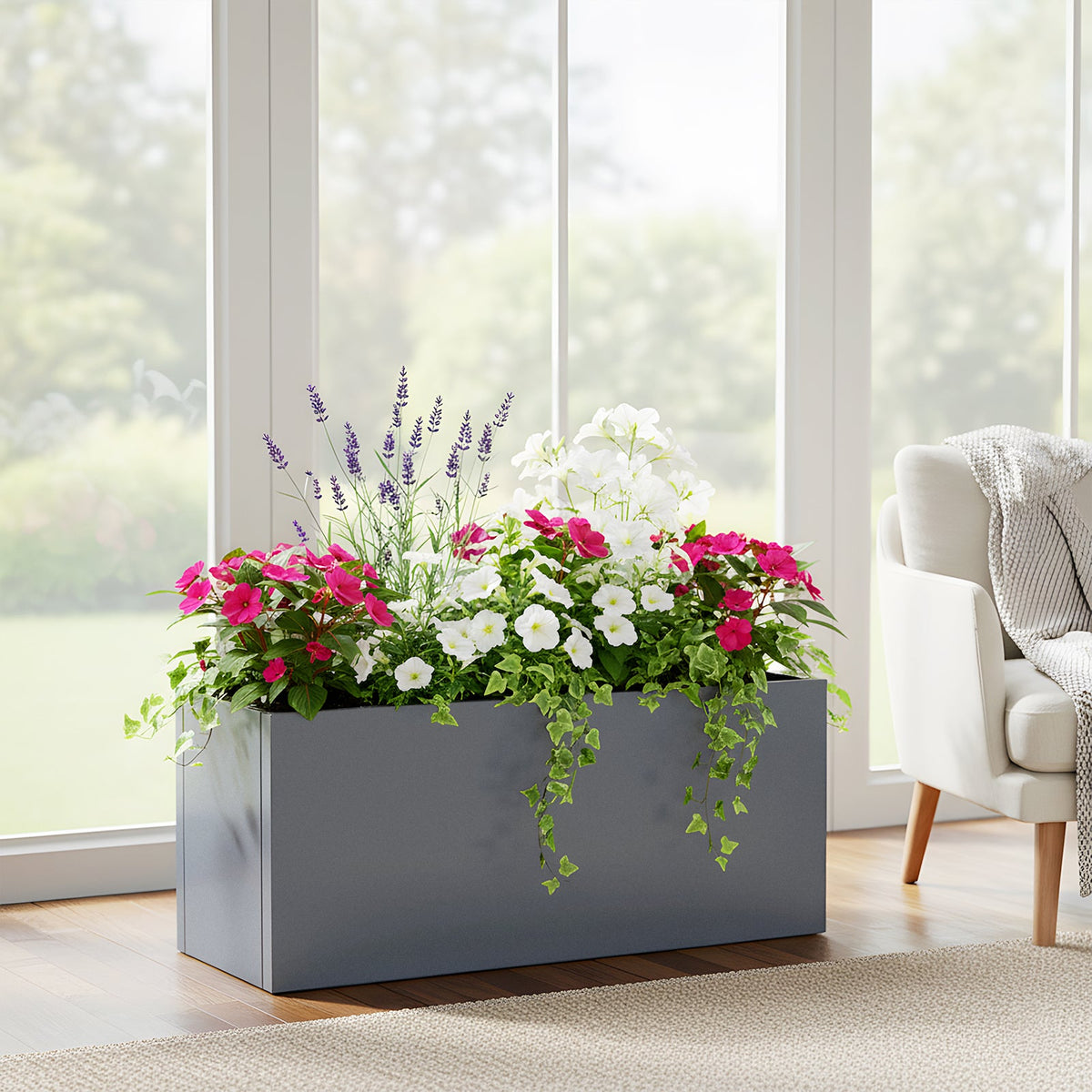 Grey metal planter with pink and white flowers in a bright conservatory