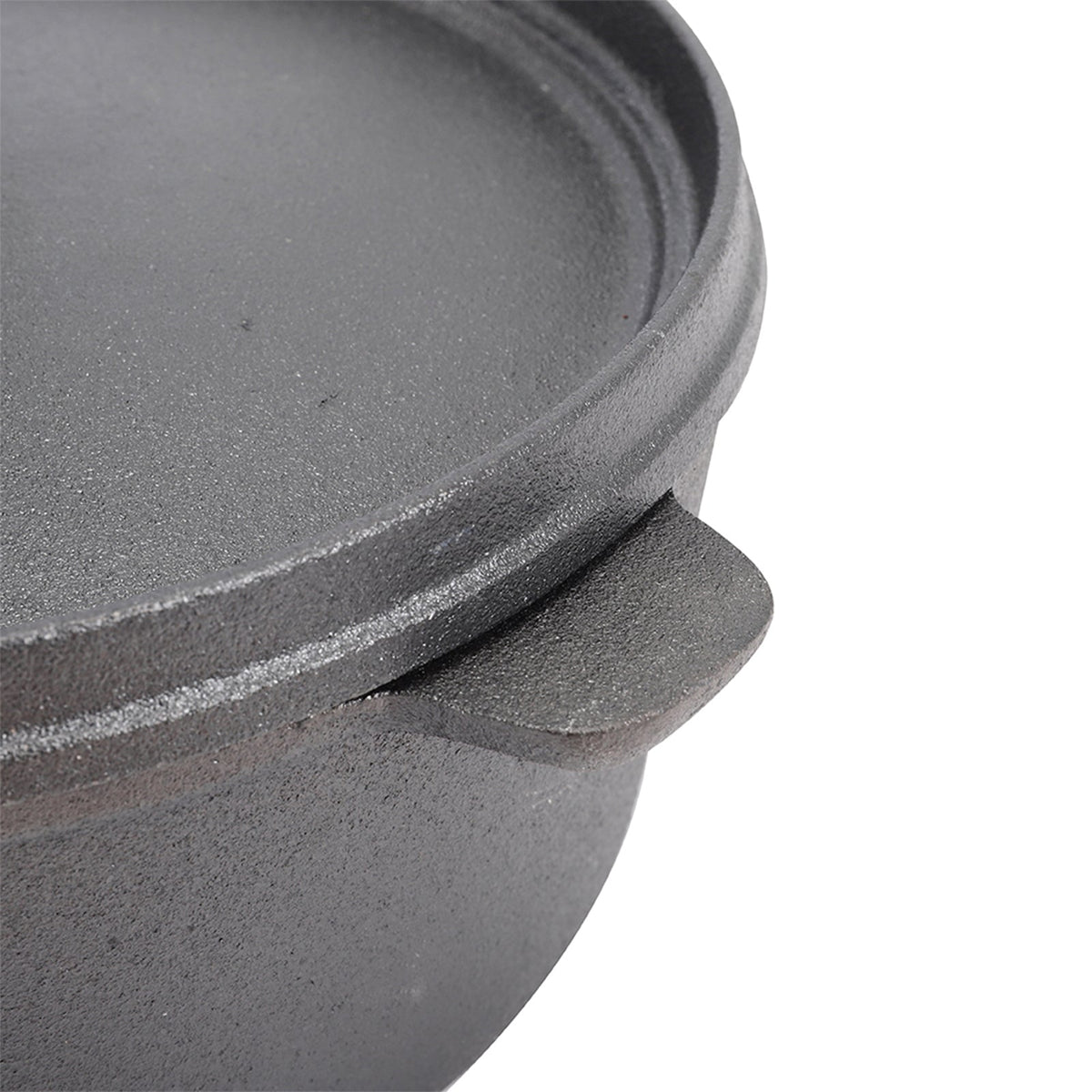 Close-up of a cast side lug and the raised edge of the cast iron lid
