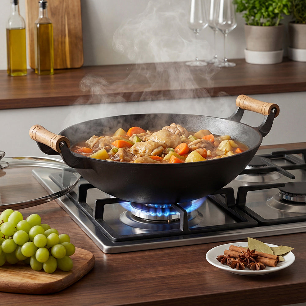 Steaming chicken and vegetables in the cast iron wok on a gas hob