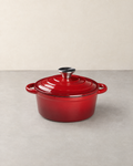 Red enamelled cast iron Dutch oven with its ringed lid and steel knob