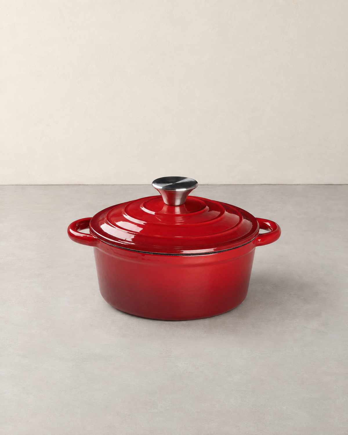 Red enamelled cast iron Dutch oven with its ringed lid and steel knob
