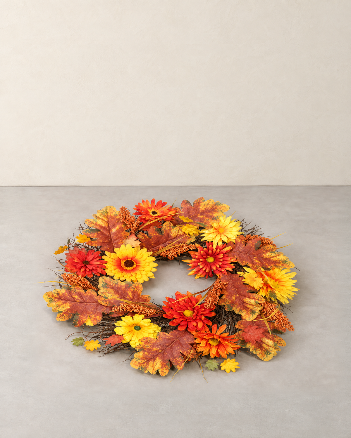 Autumn wreath of orange and yellow daisies, maple leaves and sorghum, lying flat