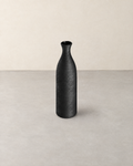 Tall slim black porcelain bottle vase with a brushed texture