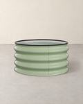 Round sage green corrugated steel raised garden bed with a black rubber rim, empty