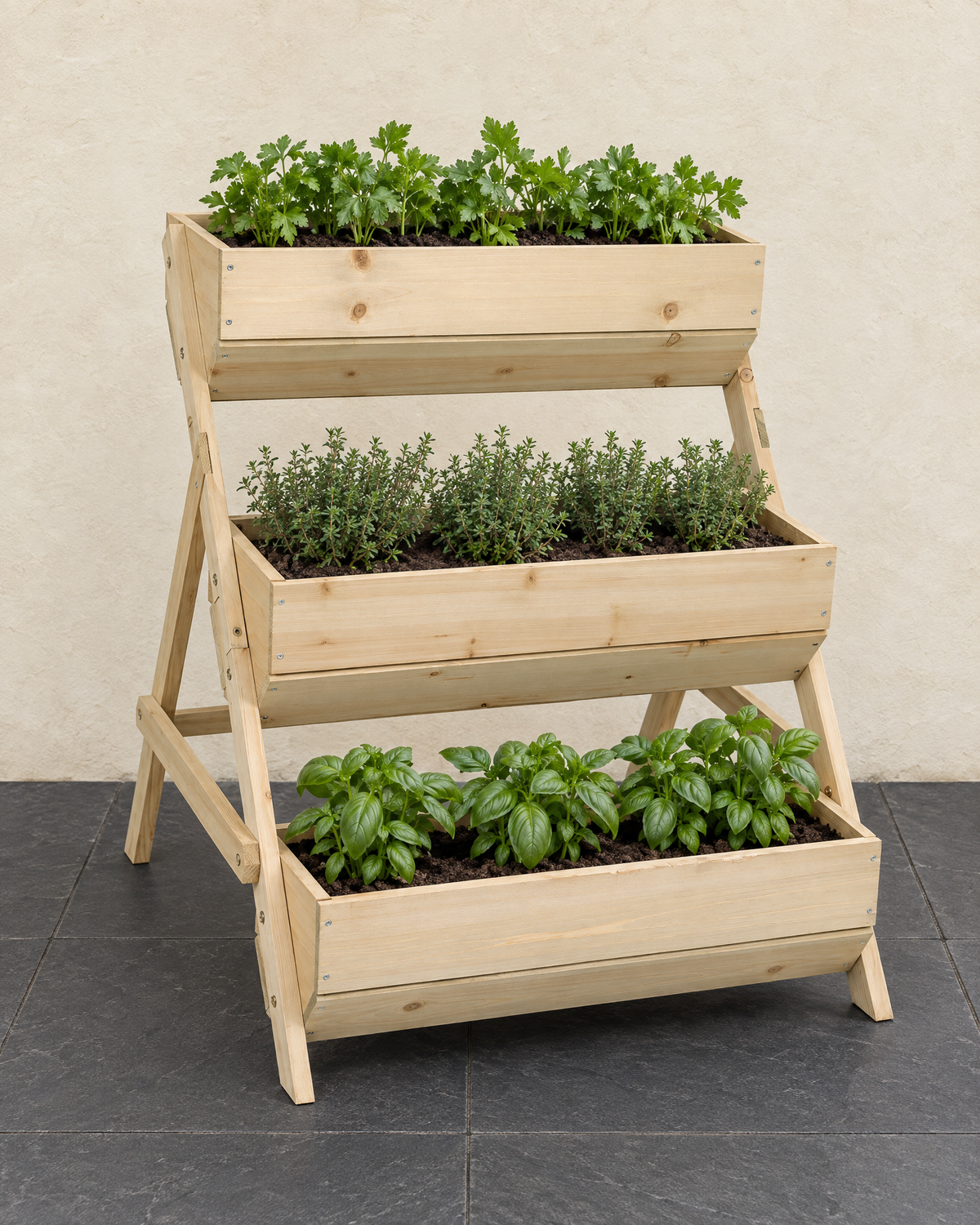 Natural wood three-tier planter planted with parsley, thyme and basil on slate paving
