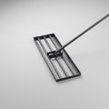 Lawn levelling rake with a black steel grid head and a long silver stainless steel handle on a grey background